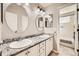 Well-lit bathroom with double sinks, granite countertop, and large mirrors, ideal for a Gathering at 3416 Hawthorne Dr, Highlands Ranch, CO 80126