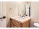 Bathroom features a neutral vanity with a built-in sink, framed mirror, and chrome hardware at 3416 Hawthorne Dr, Highlands Ranch, CO 80126