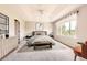 Tranquil bedroom features tray ceiling, bench, and a large window with outdoor views at 3416 Hawthorne Dr, Highlands Ranch, CO 80126