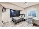 A bedroom featuring a gray bed, a small nightstand and a window at 3416 Hawthorne Dr, Highlands Ranch, CO 80126