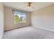 Bright bedroom featuring neutral walls, large window with a view, and carpeted floors at 3416 Hawthorne Dr, Highlands Ranch, CO 80126