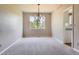 Open dining room with neutral carpeting and a chandelier fixture at 3416 Hawthorne Dr, Highlands Ranch, CO 80126