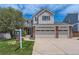 Charming two-story home featuring a three-car garage, well-manicured lawn, and inviting curb appeal at 3416 Hawthorne Dr, Highlands Ranch, CO 80126