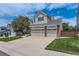 Exterior elevation of home with three car garage, brick accents and a well manicured lawn at 3416 Hawthorne Dr, Highlands Ranch, CO 80126