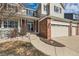 Inviting home exterior with brick accents, manicured lawn, and well-defined walkway at 3416 Hawthorne Dr, Highlands Ranch, CO 80126