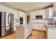 Modern kitchen with stainless steel appliances, granite countertops, and white cabinets at 3416 Hawthorne Dr, Highlands Ranch, CO 80126