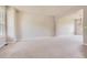 Expansive living room with neutral carpeting and plenty of natural light at 3416 Hawthorne Dr, Highlands Ranch, CO 80126