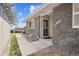 Inviting brick home entrance with modern door and well-maintained walkway and the house number '9822' at 9822 Orangewood Dr, Thornton, CO 80260