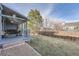 Fenced backyard with a deck, grill, and a small grassy area at 4234 S Bahama St, Aurora, CO 80013