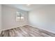 Well-lit bedroom with modern wood-look floors and neutral walls, ready for personalization at 4234 S Bahama St, Aurora, CO 80013