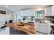 Modern kitchen with white cabinets, wood island, and stainless steel appliances at 4234 S Bahama St, Aurora, CO 80013