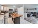 Modern kitchen featuring a wood island, stainless steel appliances and view to the living room at 4234 S Bahama St, Aurora, CO 80013