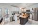 Bright, modern kitchen with white cabinets, wood island, and stainless steel appliances at 4234 S Bahama St, Aurora, CO 80013