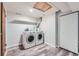 Laundry room with front load washer and dryer, storage shelf, and utility closet at 4234 S Bahama St, Aurora, CO 80013