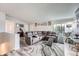 Spacious living room featuring wood floors, a sectional sofa, and natural light at 4234 S Bahama St, Aurora, CO 80013