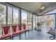 Sunroom with wood-planked flooring and access to the backyard at 4234 S Bahama St, Aurora, CO 80013