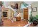 Elegant entryway with hardwood floors, a grand staircase, and a view into the living area at 4812 Moonshine Ridge Trl, Parker, CO 80134