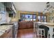 Modern kitchen with stainless steel appliances and wood cabinetry at 4812 Moonshine Ridge Trl, Parker, CO 80134