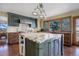 Modern kitchen with granite countertops, custom cabinetry, and stainless steel appliances at 4812 Moonshine Ridge Trl, Parker, CO 80134