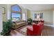 Living room with a large window offering mountain views and comfortable seating at 4812 Moonshine Ridge Trl, Parker, CO 80134