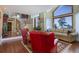 Bright living room with hardwood floors, a staircase, and large windows at 4812 Moonshine Ridge Trl, Parker, CO 80134