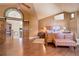 Main bedroom with barn doors, hardwood floors, and sitting area at 4812 Moonshine Ridge Trl, Parker, CO 80134