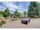 Stone patio with fire pit and landscaping at 4812 Moonshine Ridge Trl, Parker, CO 80134