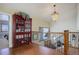 Upper landing with hardwood floors, red cabinet, and views to lower level at 4812 Moonshine Ridge Trl, Parker, CO 80134