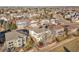 Aerial view of a residential neighborhood featuring well-maintained homes, mature trees, and community streets at 15972 W 70Th Dr, Arvada, CO 80007