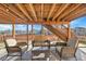 Under-deck patio with comfortable outdoor seating, a glass-top table, and string lights at 15972 W 70Th Dr, Arvada, CO 80007