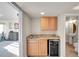 Wet bar area featuring granite countertop, cabinetry, and a beverage refrigerator at 15972 W 70Th Dr, Arvada, CO 80007