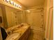 Clean bathroom with granite countertops and a shower/tub combo at 15972 W 70Th Dr, Arvada, CO 80007