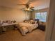 Bedroom with a bed, desk, and hanging plants at 15972 W 70Th Dr, Arvada, CO 80007