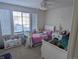 Two beds, dressers and shelving in a well-lit bedroom at 15972 W 70Th Dr, Arvada, CO 80007