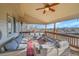 Expansive covered deck boasts comfortable seating, wood floors, and scenic views at 15972 W 70Th Dr, Arvada, CO 80007