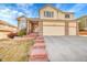 Lovely two-story home with a three-car garage and brick accents, offering curb appeal at 15972 W 70Th Dr, Arvada, CO 80007