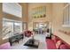 Spacious living room featuring a piano, high ceilings, and adjoins dining area at 15972 W 70Th Dr, Arvada, CO 80007