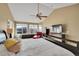 Bright, spacious main bedroom with vaulted ceiling, large windows, and elegant furnishings at 15972 W 70Th Dr, Arvada, CO 80007