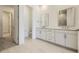 Elegant bathroom featuring a double vanity with a contemporary design and ample lighting at 15586 W Beloit Ave, Morrison, CO 80465