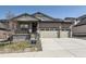 Charming single-Gathering home featuring a two-car garage, stone accents, and an inviting front porch at 15586 W Beloit Ave, Morrison, CO 80465