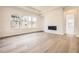 Living room features lots of natural light, hardwood floors and a modern fireplace at 15586 W Beloit Ave, Morrison, CO 80465