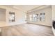 Bright and airy living room showcasing large windows, tray ceiling, and sleek hardwood floors at 15586 W Beloit Ave, Morrison, CO 80465