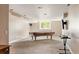 The basement boasts a pool table, natural light from the window, and a media setup for recreation and entertainment at 19052 E Briarwood Dr, Centennial, CO 80016