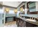 Bathroom featuring marble floors, dark wood cabinets, and gray and teal accent paint at 19052 E Briarwood Dr, Centennial, CO 80016