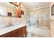 Bathroom with marble countertop vanity, dark wood cabinet, and walk-in shower with glass door at 19052 E Briarwood Dr, Centennial, CO 80016