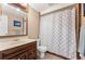 Cozy bathroom featuring classic fixtures, a shower-tub combo, and a dark wood vanity at 19052 E Briarwood Dr, Centennial, CO 80016