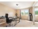 Bedroom featuring a glass desk, large windows, a silver chair, and speakers at 19052 E Briarwood Dr, Centennial, CO 80016