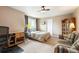 Bedroom featuring a queen bed, a dark wood cabinet, a striped sofa, and a view of the outdoors at 19052 E Briarwood Dr, Centennial, CO 80016