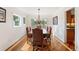 Elegant dining room featuring hardwood floors, a large window, and a stylish chandelier at 19052 E Briarwood Dr, Centennial, CO 80016