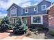 Charming two-story home with a blue exterior, brick accents, landscaped yard, and mature trees at 19052 E Briarwood Dr, Centennial, CO 80016
